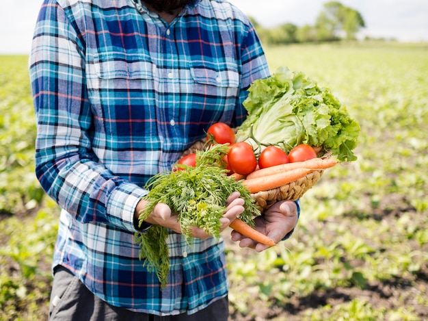 Man holding a bunch of vegetables