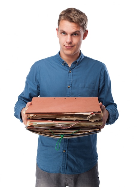 Free Photo man holding a bunch of work folders