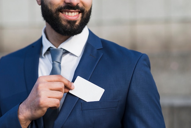 Free photo man holding business card