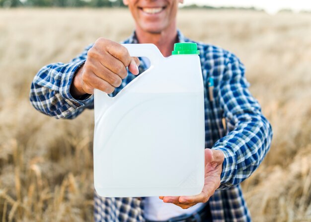 Man holding a canister with anti pests 