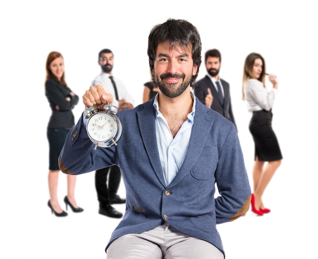 Man holding a clock over white background