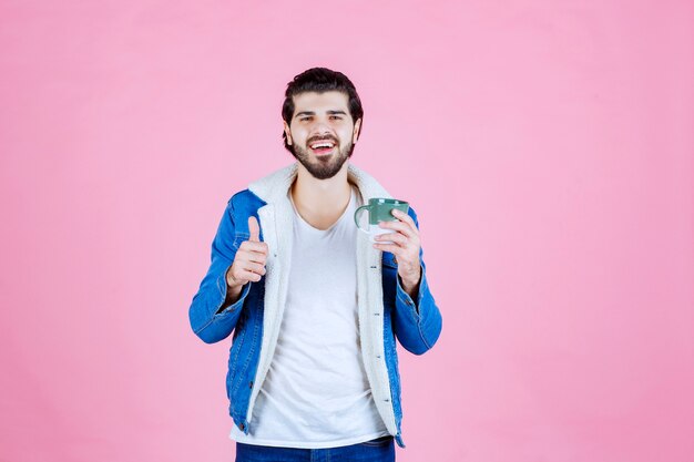 Man holding a coffee cup and enjoyed the taste