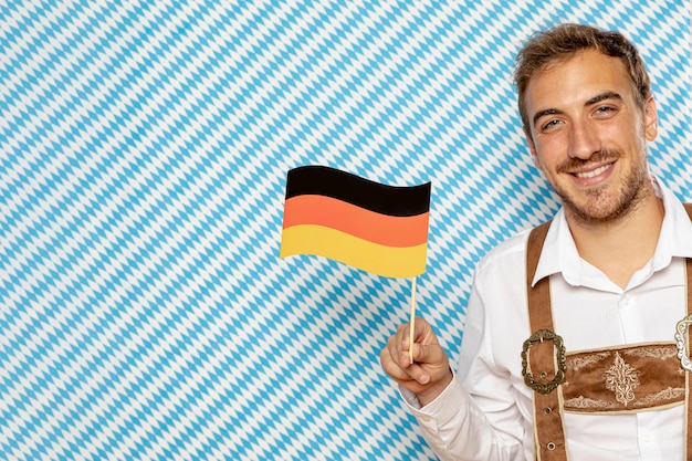 Man holding german flag with copy space