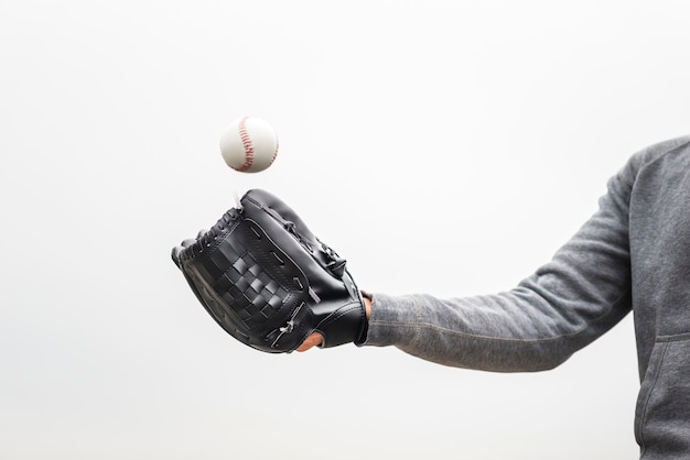 Free photo man holding glove and throwing baseball