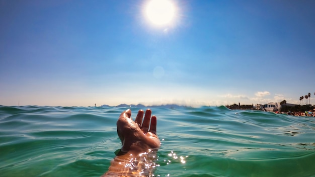 A man holding hand above the wate, Mediterranean sea