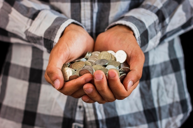 Man holding in hands saving coins