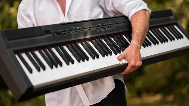 Man holding his digital piano