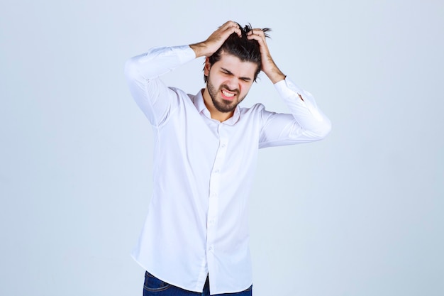 Man holding his head because of headache or feeling exhausted