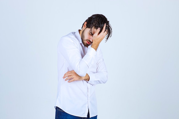 Man holding his head because of headache or feeling exhausted