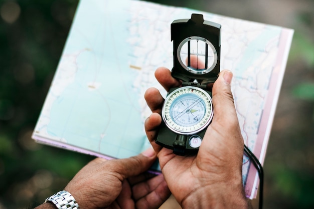 Man holding a map and a compass