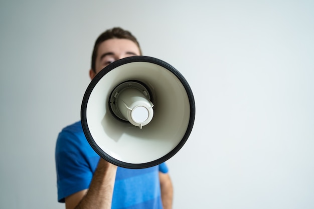 Free Photo man holding megaphone in front of his face