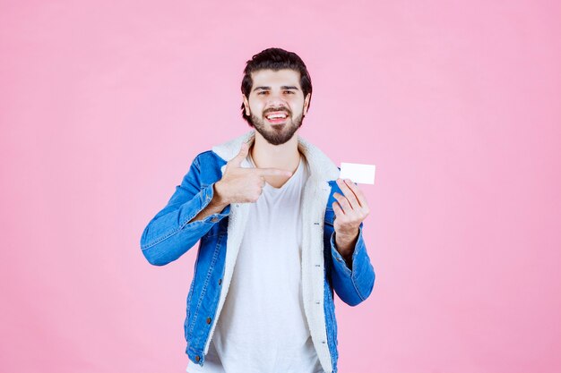 Man holding and presenting his new business card