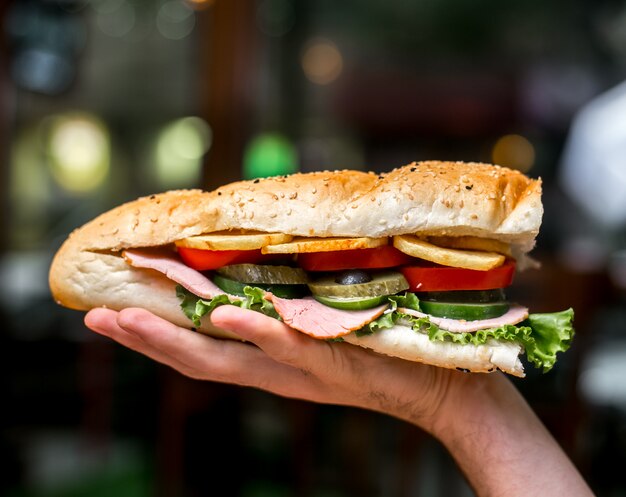 Man holding sandwich side view