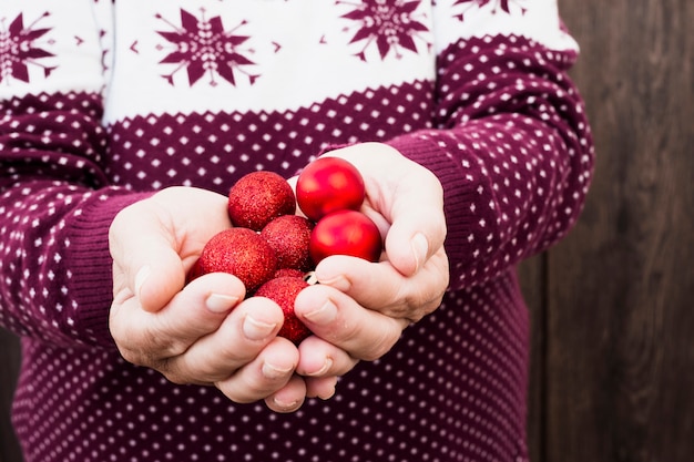 Free Photo man holding set of christmas balls