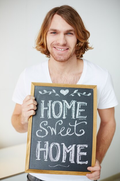 Man holding a small blackboard