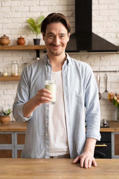 Man holding smoothie glass medium shot