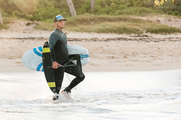 Man holding a surfing board outdoors