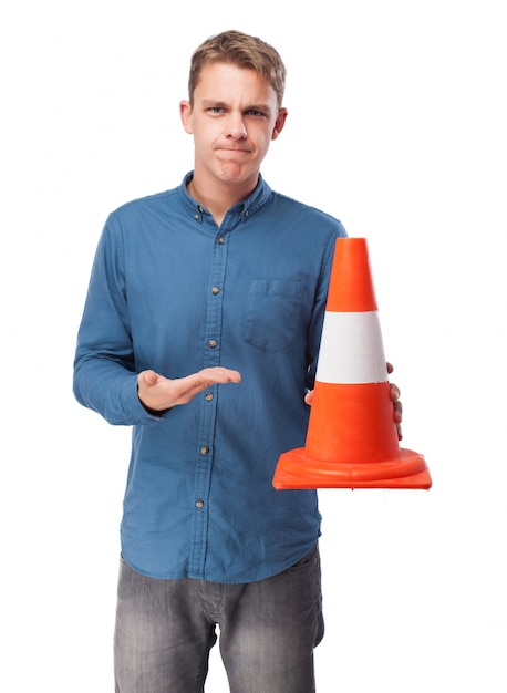 Free Photo man holding a traffic cone