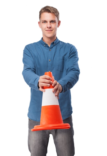 Free Photo man holding a traffic cone