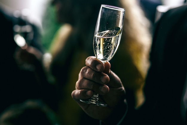 Man holds glass with champagne 