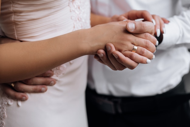 Free Photo man holds woman's hand tender in his strong arm