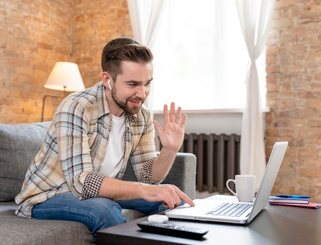 Man at home having videocall with family