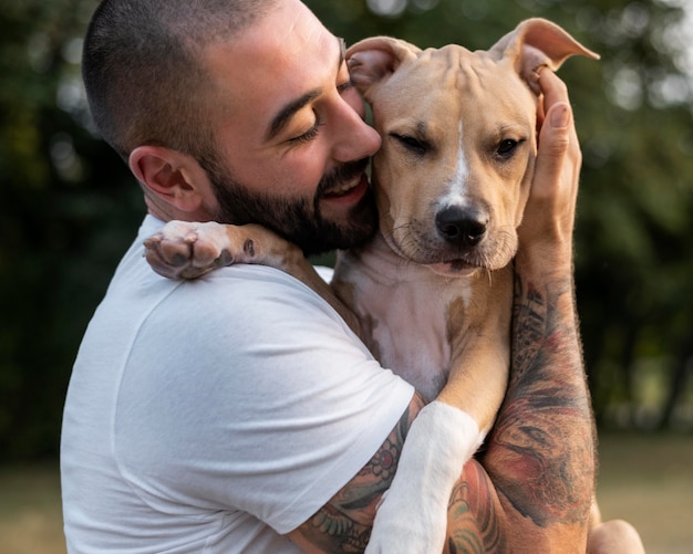 Man hugging his friendly pitbull