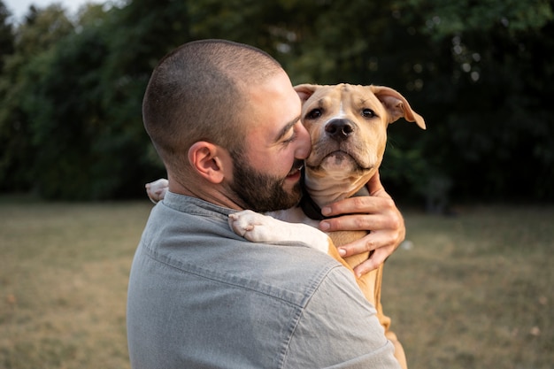 Man hugging his friendly pitbull