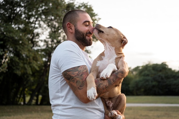 Man hugging his friendly pitbull