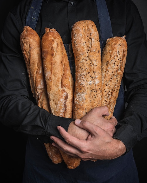 Man hugging loaves of bread