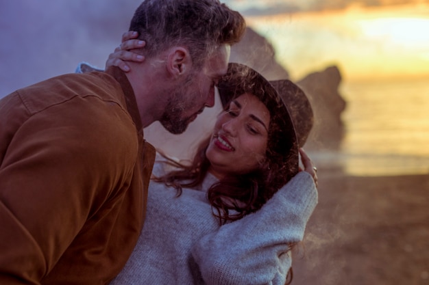 Man hugging woman on sea shore 