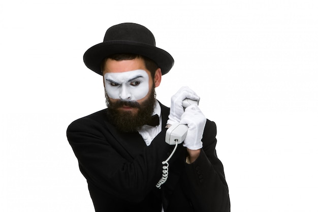 Man in the image mime holding a handset.