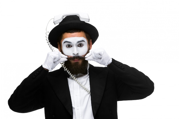 Man in the image mime holding a handset.