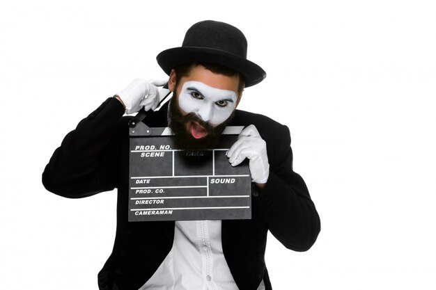 Man in the image mime with movie board