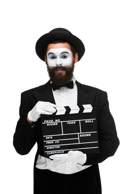 Man in the image mime with movie board