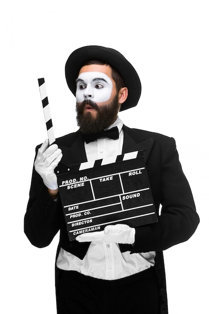 Man in the image mime with movie board