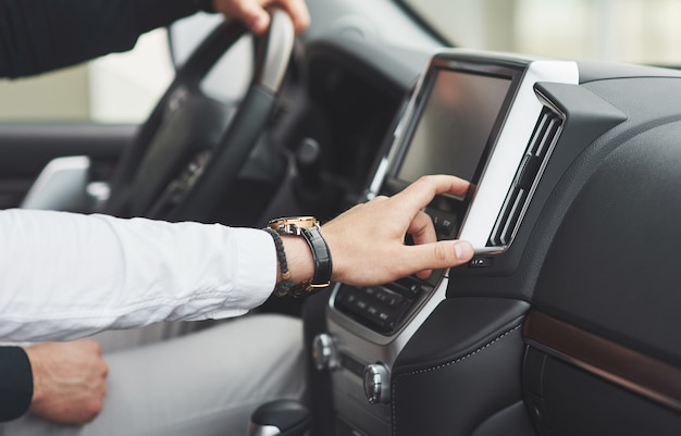 Man includes an audio system in the car.