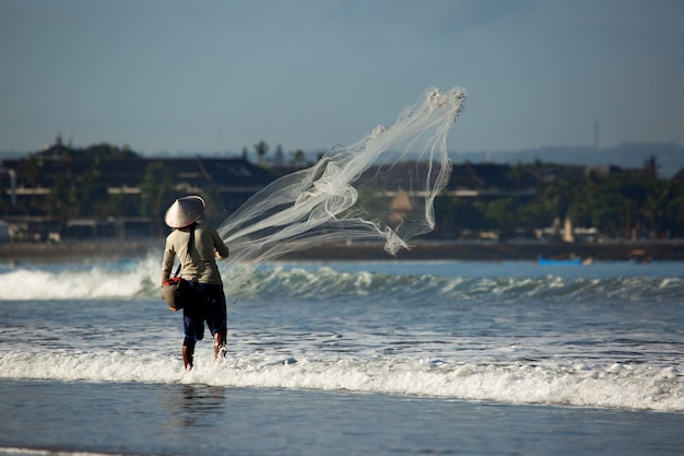 A man is fishing with a net