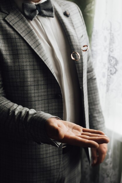 Free Photo man is tossing two wedding rings