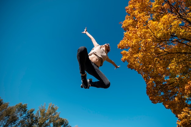 Free photo man jumping outside bottom view