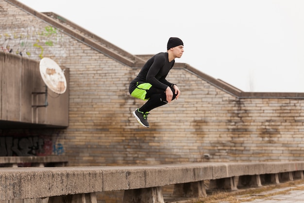 Man jumping on rooftop