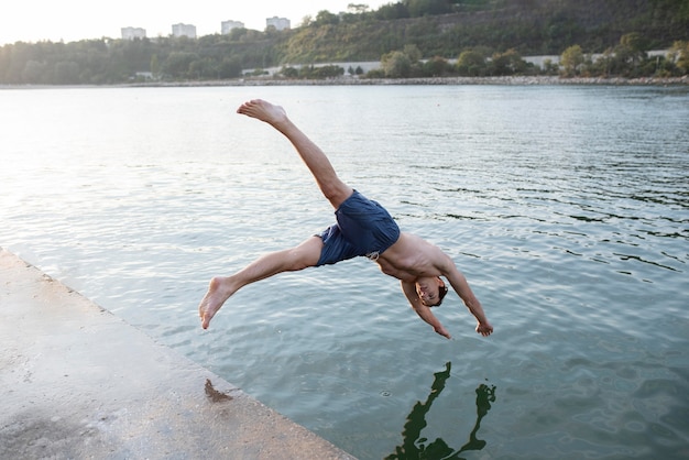 Man jumping in water full shot