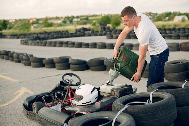 Man in a karting circuit with a car