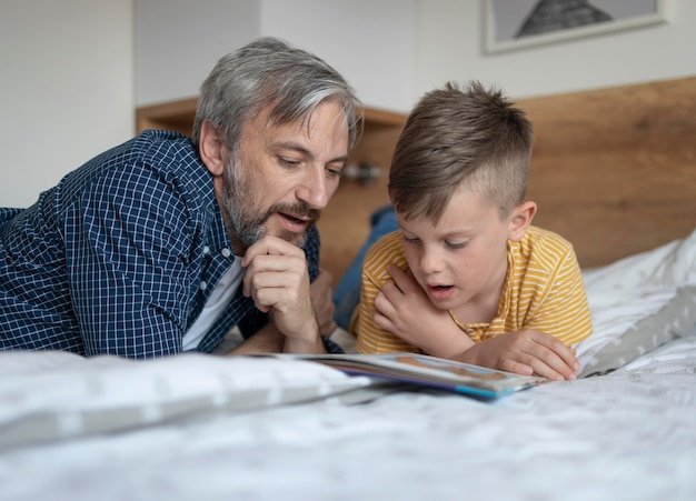 Free Photo man and kid reading medium shot