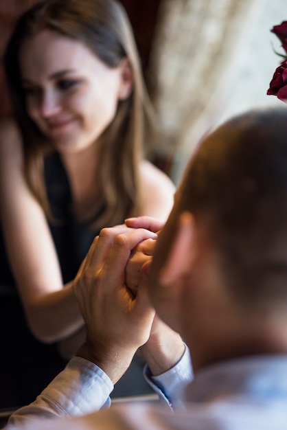 Free Photo man kissing hand of smiling woman 