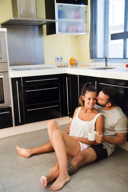 Man kissing his wife in kitchen