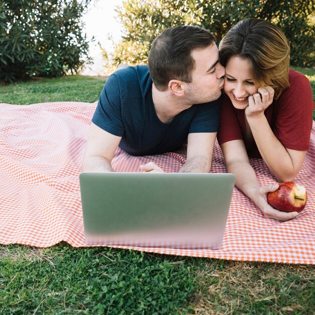 Man kissing woman in cheek