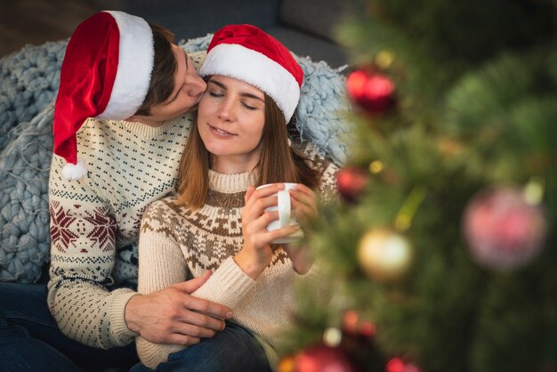 Man kissing woman with drink