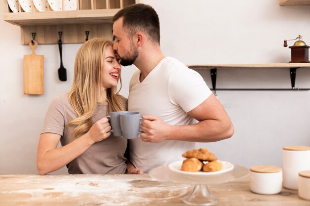 Man kissing womans forehead