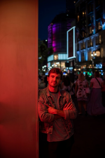 Free Photo man leaning on a wall and looking at camera